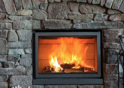 A fireplace with fire burning in it.