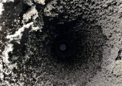 A hole in the ground with dirt and cement