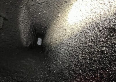 A light shining in the dark inside of a building.